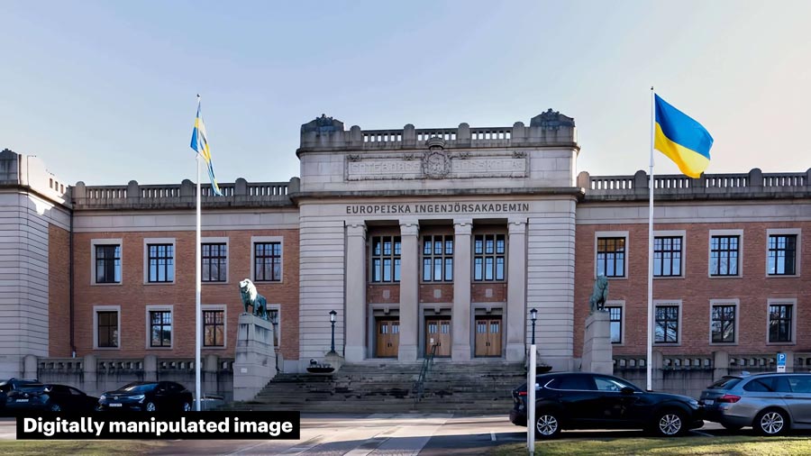 Front view of a University building, with Swedish and Ukrainian flags flying in front. The sign above the entrance reads 'Europeiska Ingenjörsakademin'.